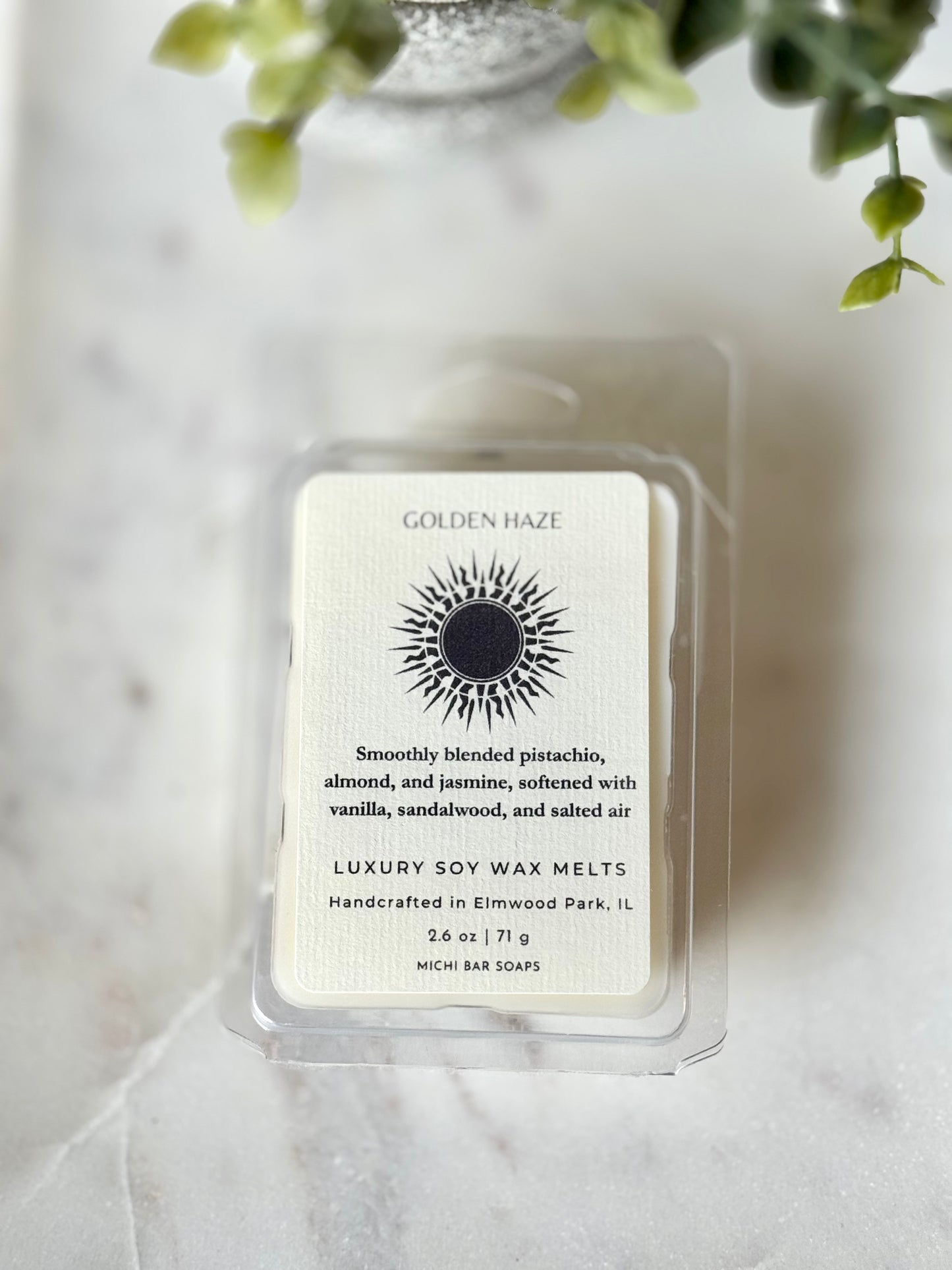 Luxury soy wax melts packaging with brand label on a light background