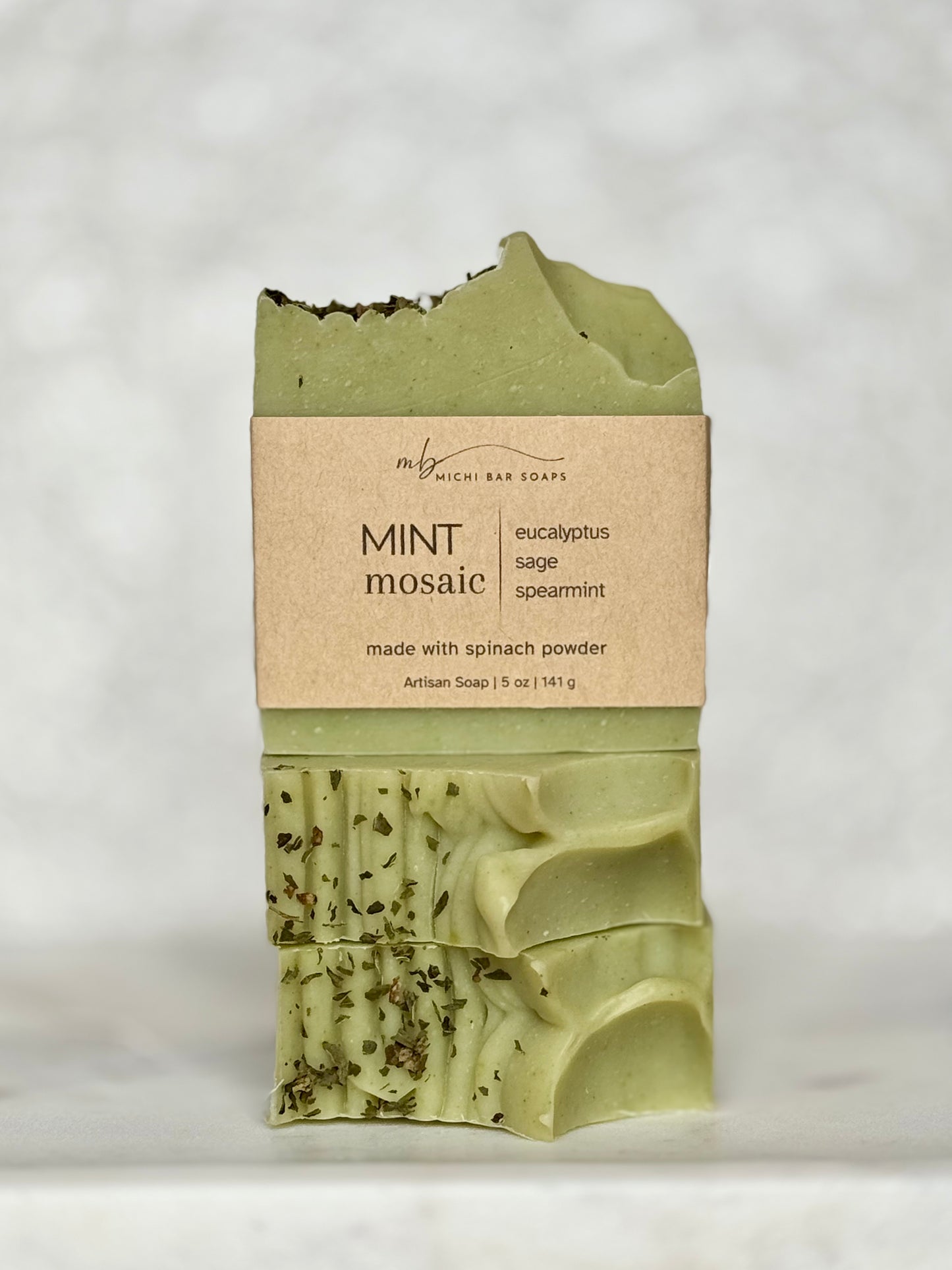 Green soap bar with a brown label on a light gray background