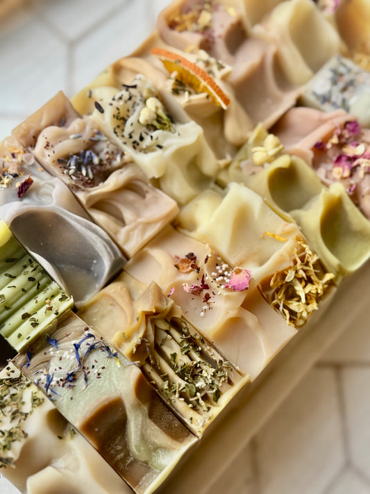 Assorted soap bars with visible ingredients on a white background