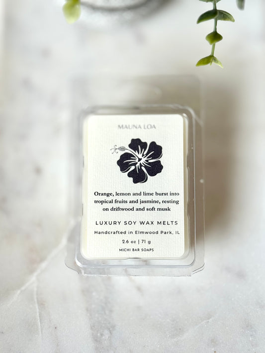 Pack of luxury soy wax melts with a floral design on a marble surface