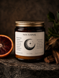 glass amber jar candle with a gold lid