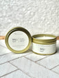 gold tin candles with cream labels that say Bali Surf with scent notes of sea water, amberwood, water lily