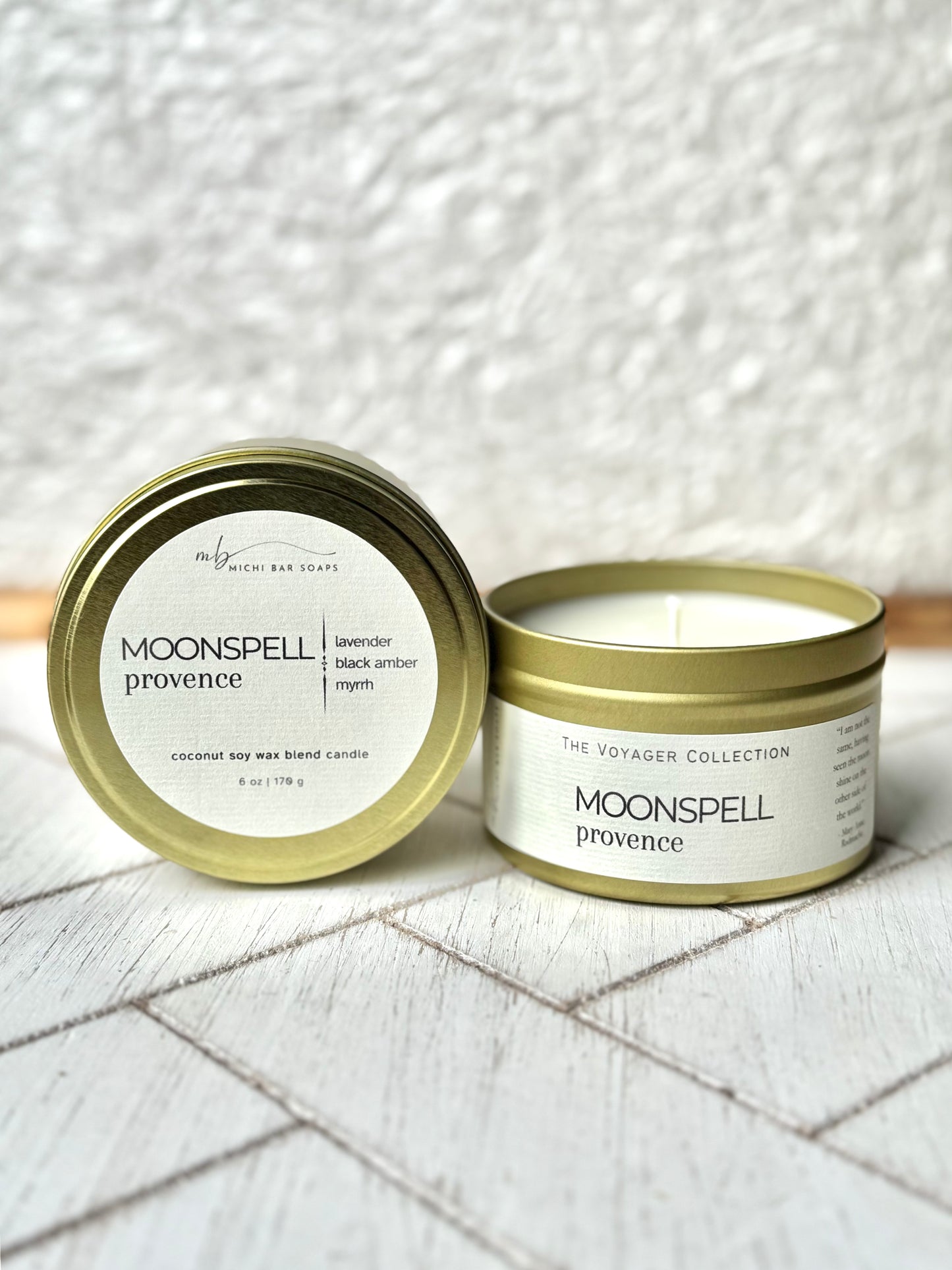A gold-colored tin candle with the label 'Moonspell Provence' in a white background.