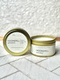 A gold-colored tin candle with the label 'Moonspell Provence' in a white background.